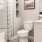 Bath with single vanity and large mirror with plenty of light.