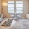Two-Bedroom Apartments In Sparks, NV - Waterfront At The Marina - Living Room With Wood-Style Flooring, Area Rug, Sofa, Coffee Table, 4-Seater Dinette, and Access to Patio
