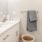 Bath with single vanity and large mirror with plenty of light.