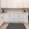 Sparks, NV Apartments For Rent - Waterfront at the Marina - Kitchen with Wood-Style Flooring, Area Rug, Stainless-Steel Appliances, Quartz Countertops, and Custom Cabinetry