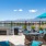 Sparks, NV Apartments - Waterfront at the Marina - Rooftop Deck with Views of the Mountains and Water, a Silver Grill Station, Seating, and Plant Beds